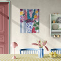 Colorful floral painting on a wall above a dining table with decorative elements.